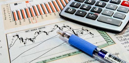 8801484-calculator-and-pen-on-business-newspaper-showing-chart-and-graph-background-Stock-Photo